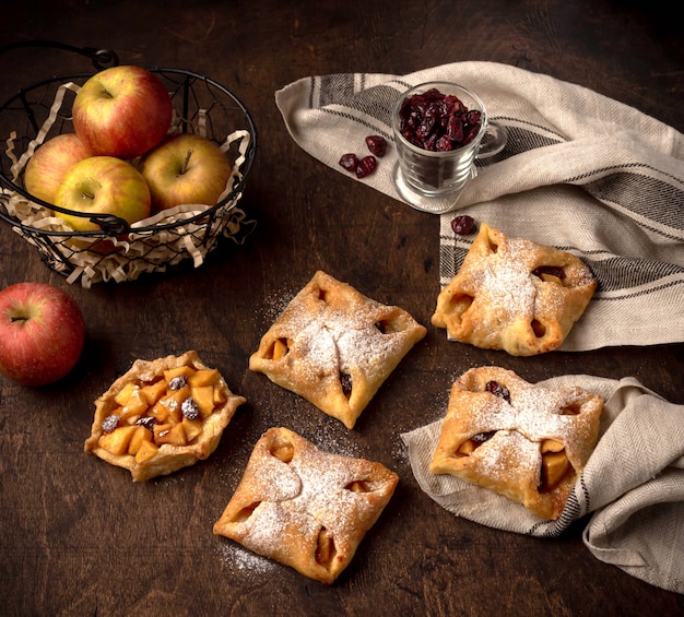 Sabrosas mini tartas de manzana con azúcar en polvo sobre un fondo rústico oscuro