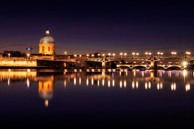 Saint Pierre Brücke und Saint Joseph Chapel in der Nacht. Erstaunliches Spiegelbild im Fluss Garonne. Toulouse, Frankreich. Europa