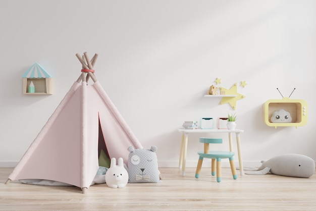 Foto sala de juegos para niños con carpa y mesa sentado detrás de la pared blanca.