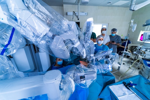 Sala quirúrgica en el hospital con equipo de tecnología robótica cirujano de brazo de máquina en quirófano futurista Robot médico quirúrgico mínimamente invasivo