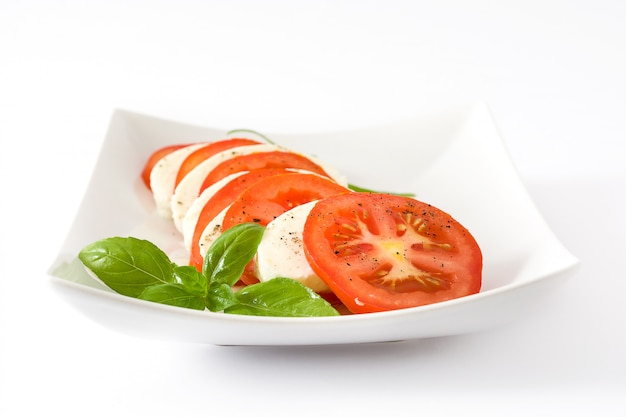 Salada Caprese com tomate mussarela e manjericão, isolado no fundo branco