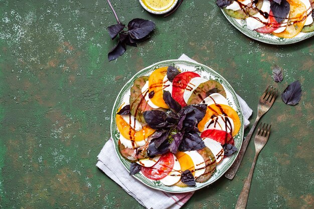 Salada caprese tomate e rodelas de mussarela com folhas de manjericão