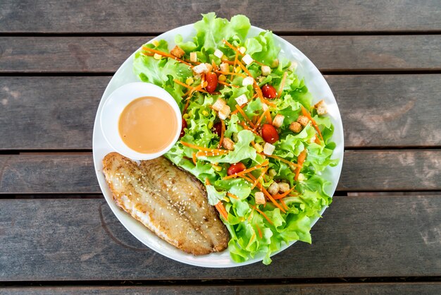 salada com filé de peixe frito