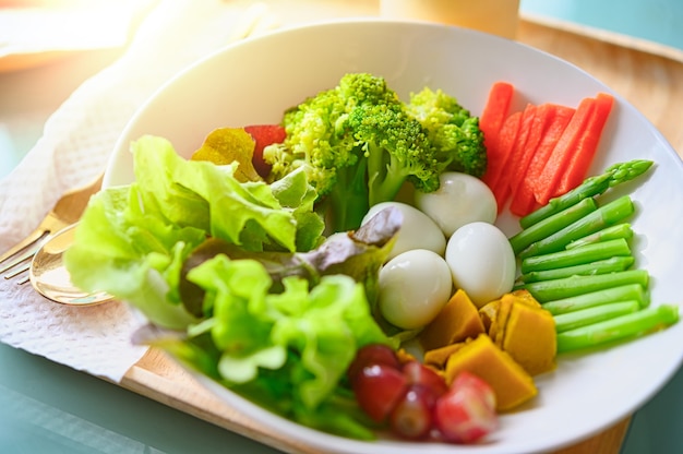 Salada com legumes e verduras na mesa de madeira