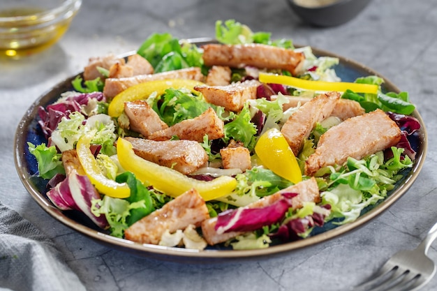 Salada com pedaços de frango servidos no prato. Fechar-se