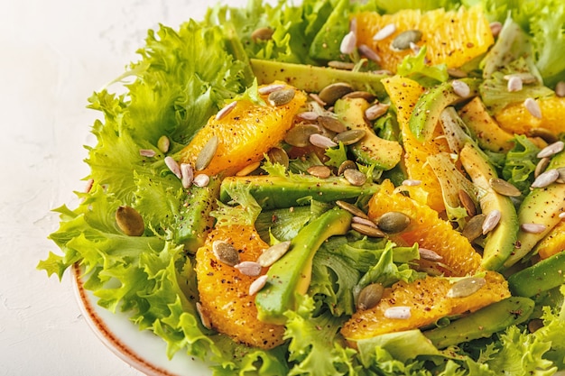 Salada de abacate laranja com sementes de abóbora e girassol.