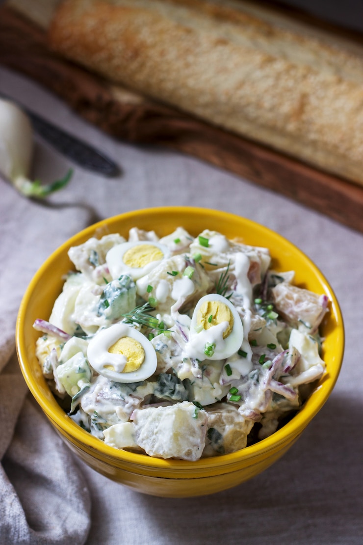 Foto salada de batata americana tradicional com ovo e maionese, servida com pão. estilo rústico.