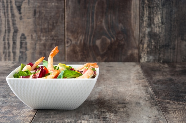 Salada de camarão com manga e abacate na mesa de madeira