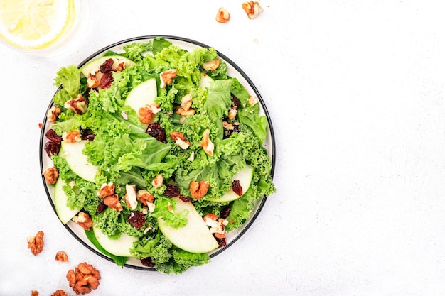 Salada de couve com maçãs verdes secas e nozes Comida saudável vista de cima mesa de cozinha branca espaço negativo