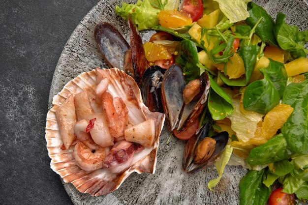 Salada de frutos do mar, tentáculos de polvo, vieiras, camarões tigre, lulas, mexilhões, abacaxi, laranja, mistura de salada, cereja, molho de laranja