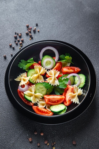 Salada de macarrão sem carne tomate pepino farfalle refeição saudável dieta lanche na mesa copiar espaço