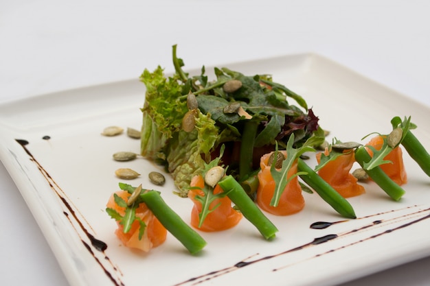 Salada de salmão, sementes de abóbora e aspargos em um prato