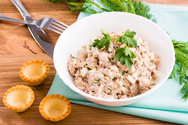 Salada de sauro enlatado e ovos de galinha e tortinhas vazias