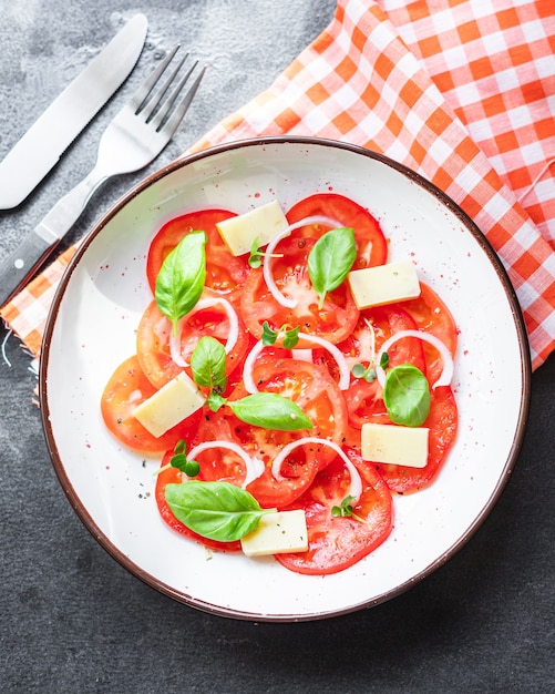 Salada de tomate e queijo vegetal, manjericão vegetal na mesa comida saudável
