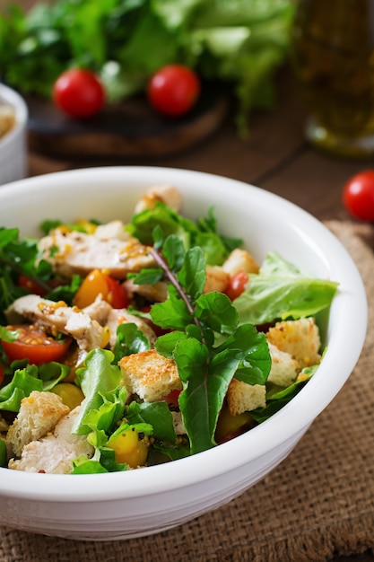 Foto salada fresca com peito de frango, rúcula, alface e tomate.