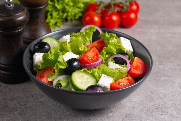 Salada grega com tomate fresco, pepino, azeitonas, queijo feta e cebola roxa. Alimentação saudável e dietética