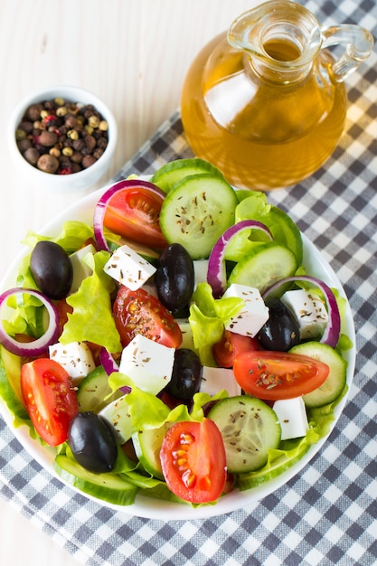 Salada grega fresca no fundo de madeira.