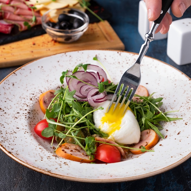 Salada quente com ovo pashot, rúcula, tomate cereja