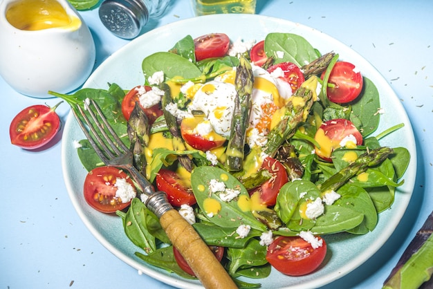 salada quente de aspargos com espinafre baby, tomate cereja, queijo feta e ovo escalfado