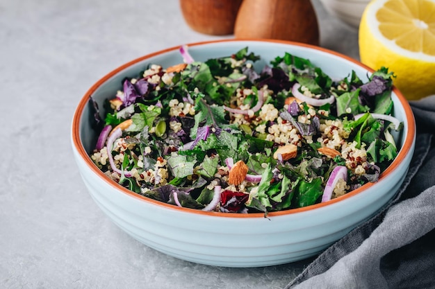 Salada saudável de couve e quinoa com cranberries secas, cebolas vermelhas e amêndoas