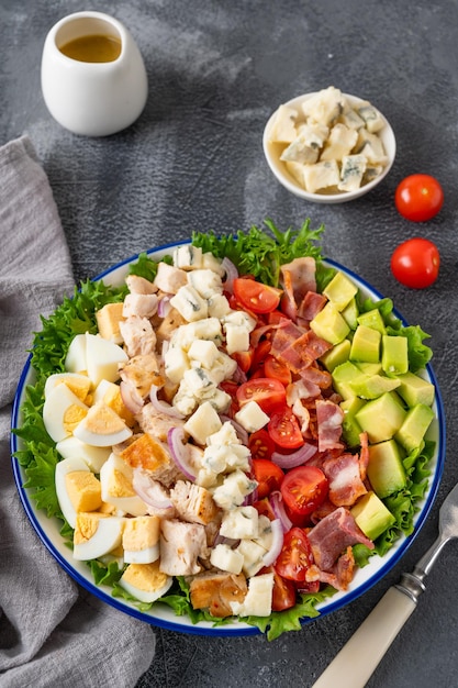 Salada tradicional Cobb com frango frito abacate tomates frescos ovos bacon e queijo