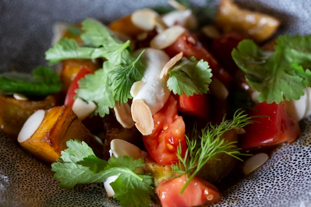 Foto salada vegetariana de berinjela com tomates de cereja de berinjelo assados e cilantro foto macro de berinjelas grelhadas e queijo cottage com sementes de sésamo de salsa fresca e óleo picante