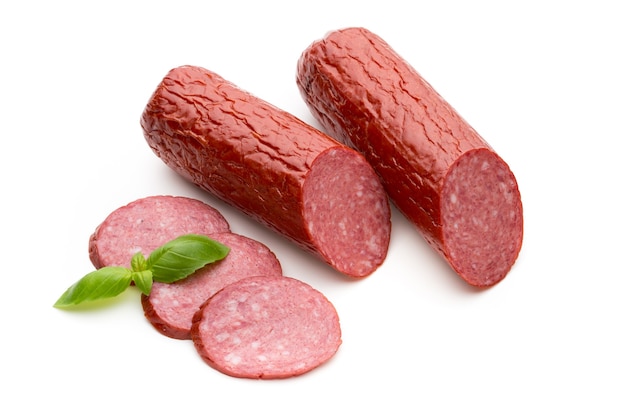 Salami salchicha ahumada, hojas de albahaca en blanco.