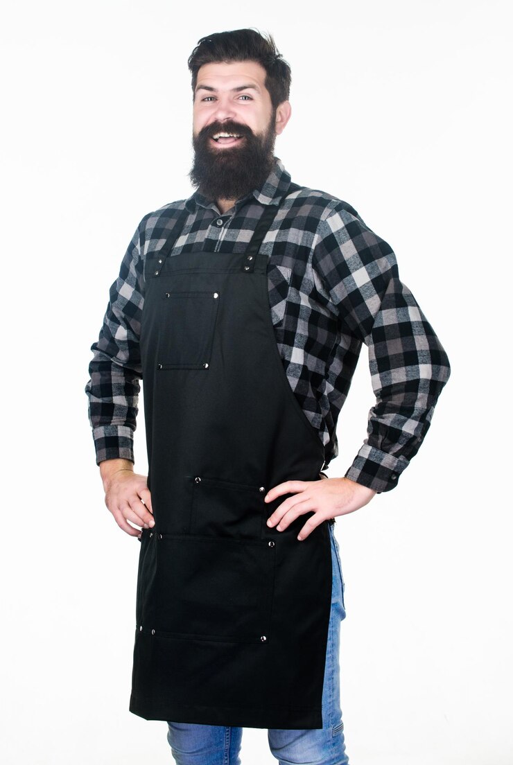 Foto salão de beleza de barba barbeiro macho bem preparado uniforme para salão de barbeiro conceito de barbearia cabeleireiro salão de barbeiro para homens homem brutal barbado hipster desgaste avental uniforme equipe de barbearia