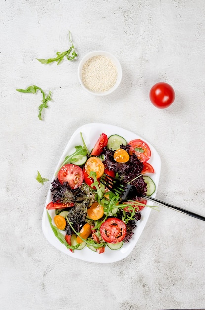 Salat mit frischen Salatblättern Rucola-Kirsch-Tomaten-Gurke