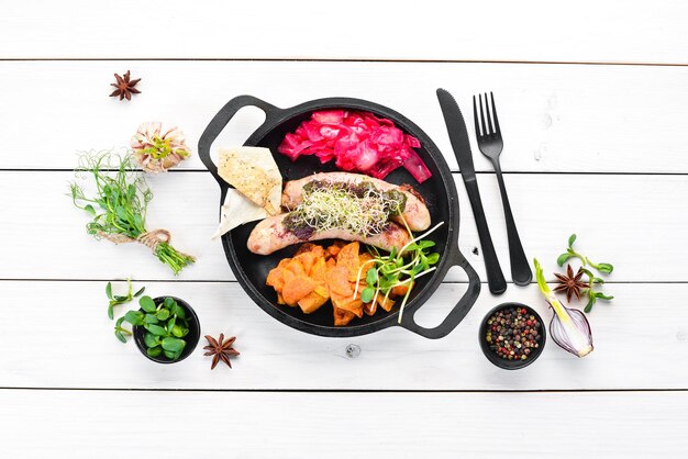 Salchichas al horno batatas y repollo En el plato Vista superior Espacio libre para su texto Estilo rústico