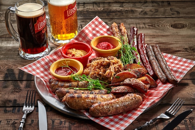 Salchichas fritas, gajos de patata, salsas de repollo guisadas como aperitivo de cerveza