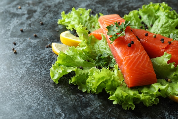 Salmão cru fresco e ingredientes para cozinhar em fumaça preta