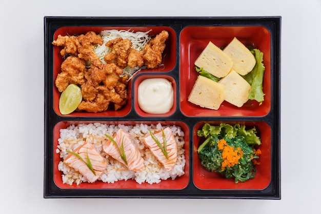 Salmón a la parrilla Bento con pollo frito japonés.