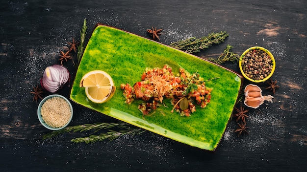 Salmón con salsa Aperitivos calientes Vista superior Sobre un fondo de madera negra Copiar espacio