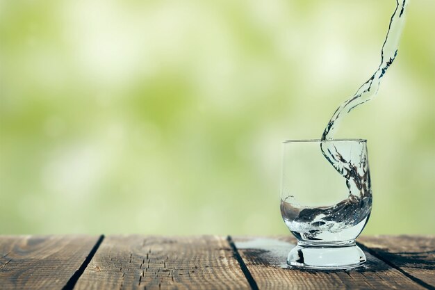 Salpicadura de agua en un vaso sobre madera