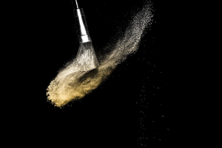 Foto salpicaduras de polvo dorado para maquillaje