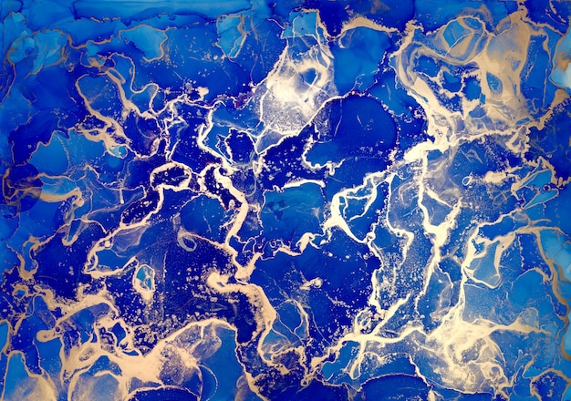Salpicaduras de tinta de alcohol azul y dorado, pintura de textura de flujo líquido