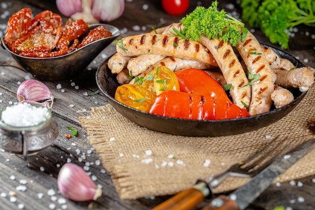 salsichas de cachorro-quente caseiras fritas de carne de peixe vermelho e branco, em uma tigela de prato rústico vintage, garfo