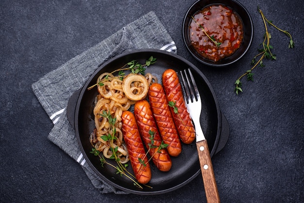 Foto salsichas grelhadas com cebola assada