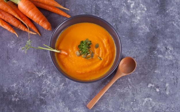 Saludable comer sopa de crema de zanahoria. Sopa de verduras vegetariana. Vista superior.