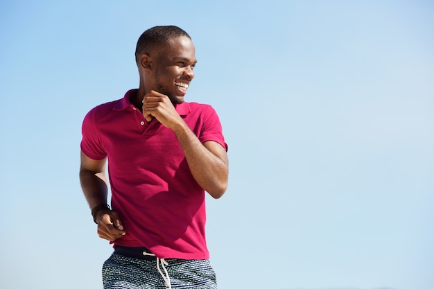 Saludable joven africano corriendo al aire libre