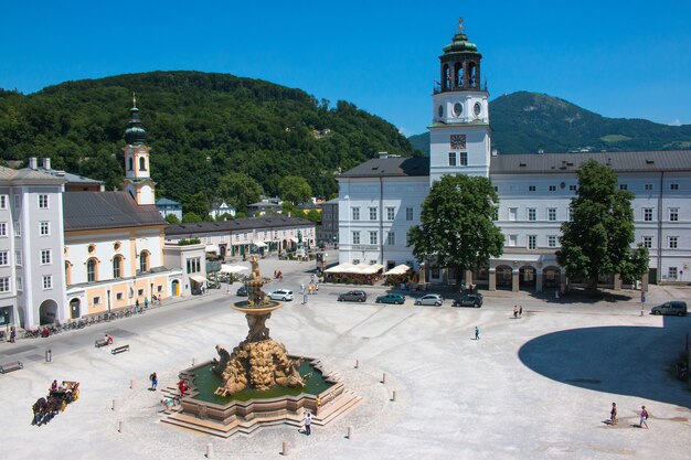 Salzburgo, Áustria-27 de junho de 2016: Vista panorâmica da Praça de Salzburgo, Áustria, Europa. Dia de verão com nuvens azuis no céu. Pessoas caminham no centro do parque