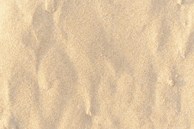 Sand Textur Hintergrund. Braunes Wüstenmuster vom tropischen Strand. Nahansicht.