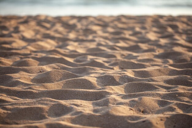 Sandhintergrund und Sonnenuntergang. texturiert