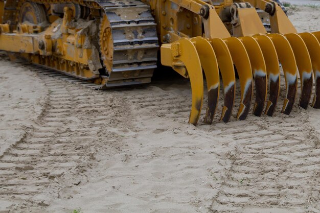 Sandreinigungsmaschine am Strand gräbt Furchen im Sand