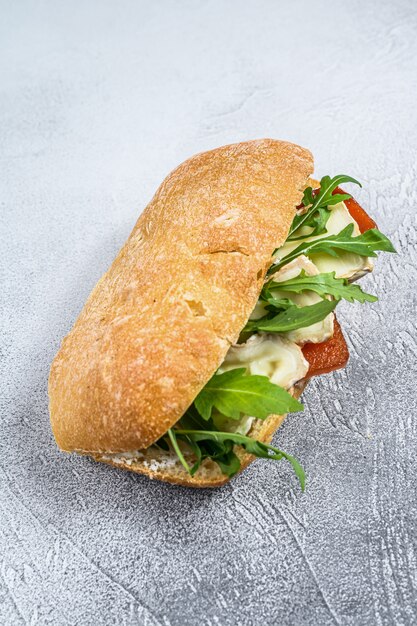 Sanduíche com queijo Camembert fresco, marmelada de pêra, ricota e rúcula. Vista do topo