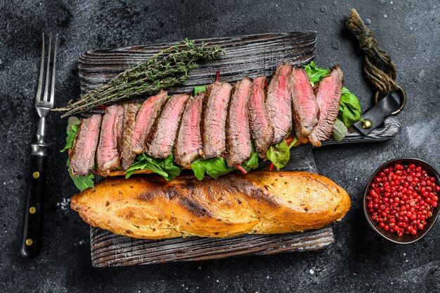 Sanduíche de bife baguete grelhado com rúcula e queijo