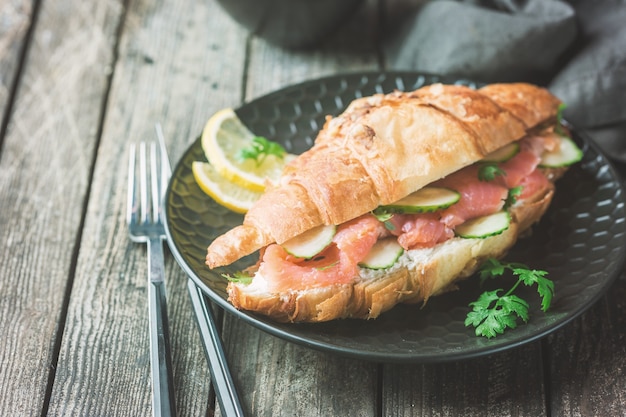 Sanduíche de salmão defumado com cream cheese fresco e pepinos na chapa preta