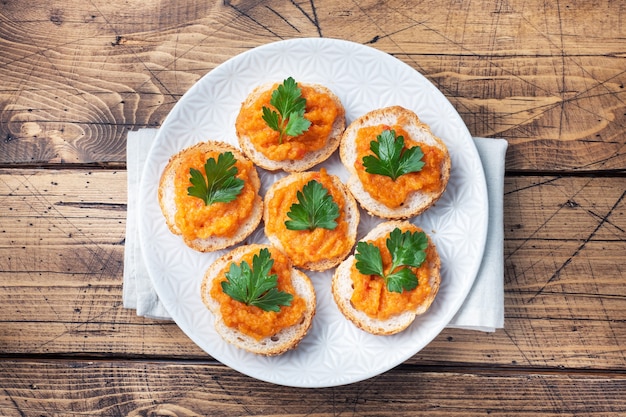 Sanduíches com cebolas de tomate de caviar de abobrinha de pão. Comida vegetariana caseira. Legumes cozidos enlatados. vista superior da superfície de madeira, espaço da cópia