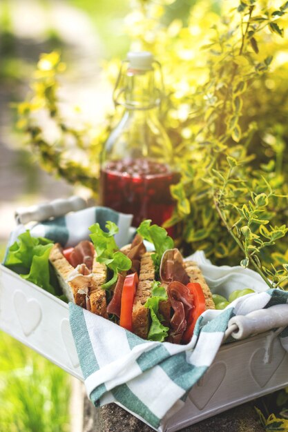 Sanduíches de presunto e vegetais em uma cesta